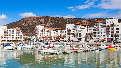 Boats at the Marina harbour in Agadir. Agadir is a major city in Morocco located on the shore of the Atlantic Ocean, near the Atlas Mountains.